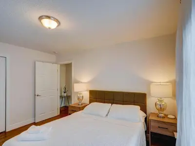 a bedroom with a large white bed and a door at Luxury Miami Casa Bonita with Tropical Pool Oasis in Miami