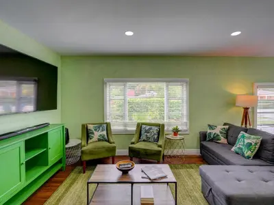 a living room with green walls and a couch and chairs at Luxury Miami Casa Bonita with Tropical Pool Oasis in Miami