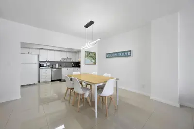 a kitchen and dining room with a table and chairs at Beautiful and big Apartment by the beach in Sunny Isles Beach