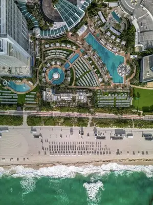 an aerial view of a beach and the ocean at FountaineBleau Resort, Balcony with Ocean & Pool View in Miami Beach