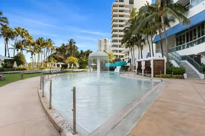 a swimming pool with a water slide in a building at FountaineBleau Resort, Balcony with Ocean & Pool View in Miami Beach