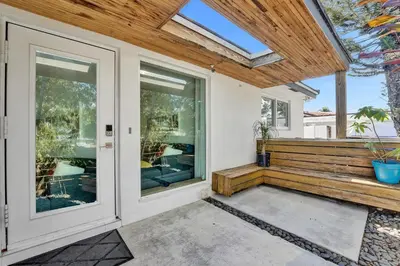 a home with a porch with sliding glass doors at Private Waterfront Paradise in Hollywood
