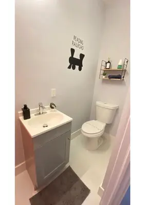 a bathroom with a toilet and a sink at Cozy Duplex near Wynwood & Beach in Miami