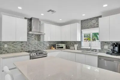 a kitchen with white cabinets and a counter top at Daddy House-victoria Park With Pool in Fort Lauderdale