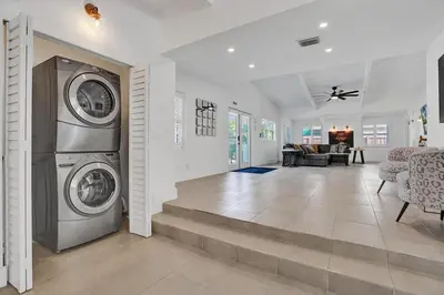 a living room with a washer and dryer in a house at New ! Pool House 3-bedroom Home Victoria Park in Fort Lauderdale