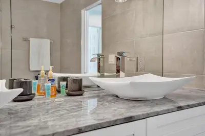 a bathroom with a large white bowl sink on a counter at New ! Pool House 3-bedroom Home Victoria Park in Fort Lauderdale