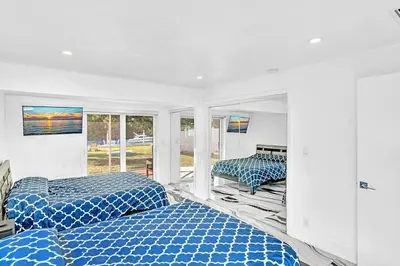a bedroom with two blue beds and a window at waterfront Ocean dream House Hollywood Hard Rock airport in Fort Lauderdale