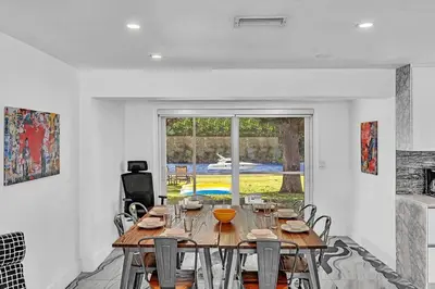 a dining room with a wooden table and chairs at waterfront Ocean dream House Hollywood Hard Rock airport in Fort Lauderdale