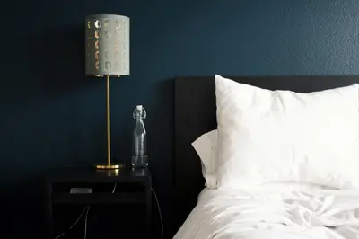 a lamp on a night stand next to a bed at Hotel Downtown Miami - DQR in Miami
