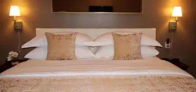 a large white bed with two pillows on it at Hotel Downtown Miami - DQR in Miami