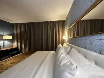 a bedroom with a large white bed and a desk at Hotel TB Downtown Miami in Miami