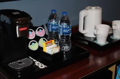 a table with two bottles of water and a coffee maker at Hotel TB Downtown Miami in Miami