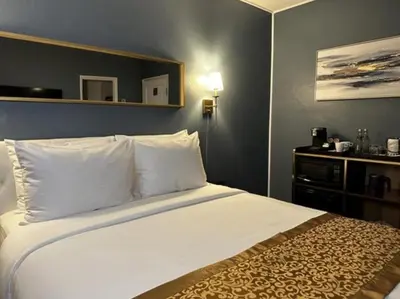 a hotel room with a bed with white sheets and pillows at Hotel TB Downtown Miami in Miami