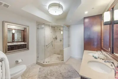 a bathroom with a shower and a toilet and a sink at Modern 2 BDR at King David with Ocean View in Sunny Isles Beach