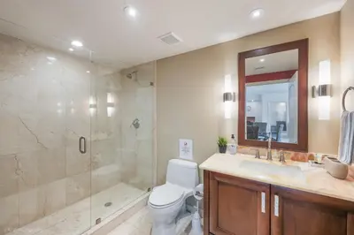 a bathroom with a shower and a toilet and a sink at Modern 2 BDR at King David with Ocean View in Sunny Isles Beach