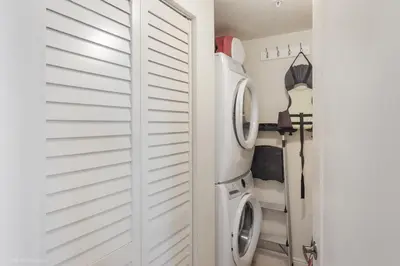 a laundry room with a washer and dryer at Modern 2 BDR at King David with Ocean View in Sunny Isles Beach
