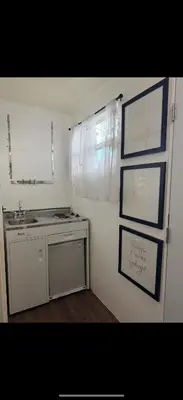 a kitchen with a sink and a counter and a mirror at Tiny house WiFi and parking in Miami