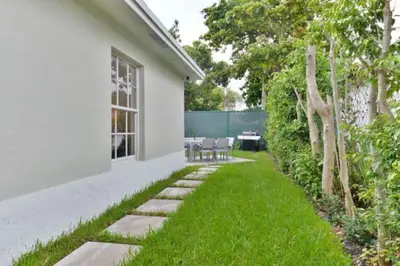 a garden with a pathway leading to a house at Wynwood Area with Hot Tub, 10 min from South Beach in Miami