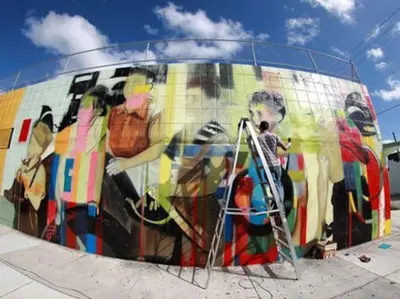 a man painting a mural on a skateboard ramp at Wynwood Area with Hot Tub, 10 min from South Beach in Miami