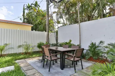 a table and chairs sitting on a patio at West Brickell GEM With Private Garden, 2BR 2BATH in Miami