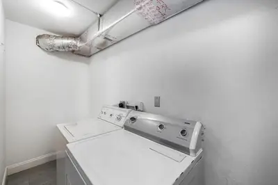 a white laundry room with a washing machine at West Brickell GEM With Private Garden, 2BR 2BATH in Miami