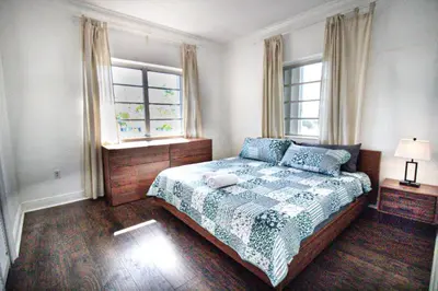 a bedroom with a bed and two windows at 3 Bedroom Apartment with BBQ and Patio, Near Brickell in Miami