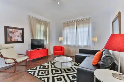 a living room with a blue couch and red chairs at 3 Bedroom Apartment with BBQ and Patio, Near Brickell in Miami