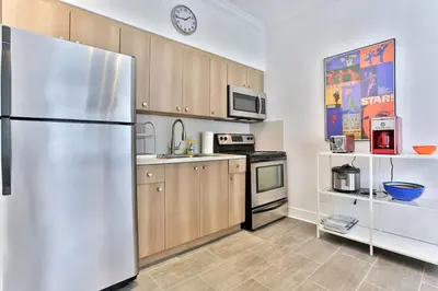 a kitchen with a stainless steel refrigerator at 3 Bedroom Apartment with BBQ and Patio, Near Brickell in Miami