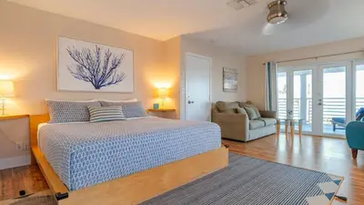 a bedroom with a bed and a living room at Winter Rate Discount Beachside Home Pool Views Beach Haven by AvantStay in Fort Lauderdale