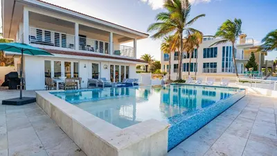 a swimming pool in front of a house at Winter Rate Discount Beachside Home Pool Views Beach Haven by AvantStay in Fort Lauderdale