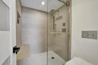 a shower with a glass door in a bathroom at Beautiful Oceanfront 3BDR Condo 801 in Miami Beach