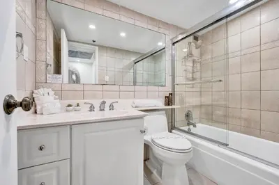 a bathroom with a toilet and a sink and a tub at Oceanfront Beach Retreat Beach Service 905 in Miami Beach