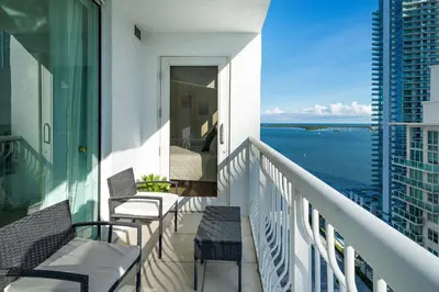 a balcony with chairs and a view of the ocean at Stylish 2BR With Skyline Views, Free Parking, Sleeps 8 in Miami