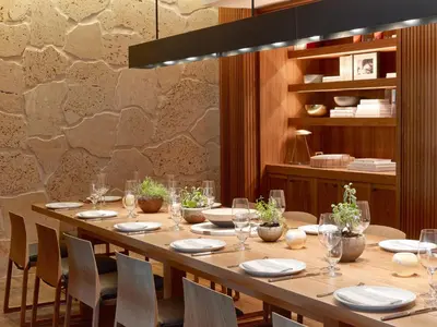 a long table in a restaurant with chairs and glasses at 1 Hotel South Beach in Miami Beach