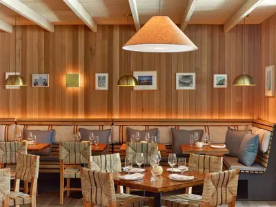 a restaurant with wooden walls and tables and chairs at 1 Hotel South Beach in Miami Beach