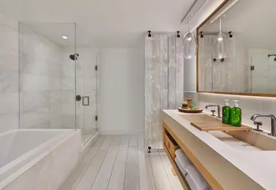 a bathroom with a tub and a sink and a shower at 1 Hotel South Beach in Miami Beach