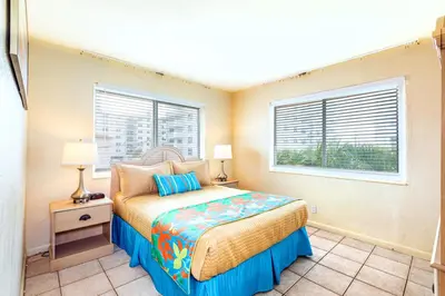 a bedroom with a bed and two windows at Enchanted Isle Hollywood Beach Resort in Hollywood
