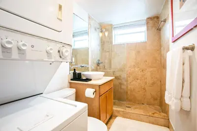 a bathroom with a toilet and a sink at Spacious Apt in the heart of South Beach in Miami Beach