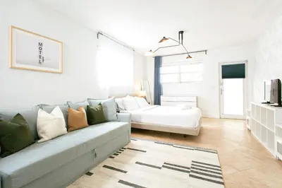 a living room with a couch and a bed at Spacious Apt in the heart of South Beach in Miami Beach
