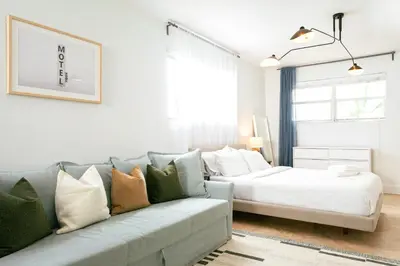 a living room with a couch and a bed at Spacious Apt in the heart of South Beach in Miami Beach