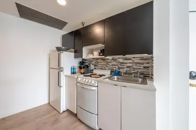 a kitchen with a white refrigerator and a sink at Amazing studio in Ocean Drive in Miami Beach