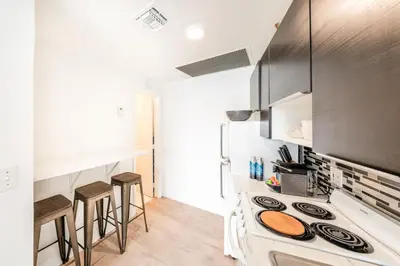a kitchen with a stove and some bar stools at Amazing studio in Ocean Drive in Miami Beach
