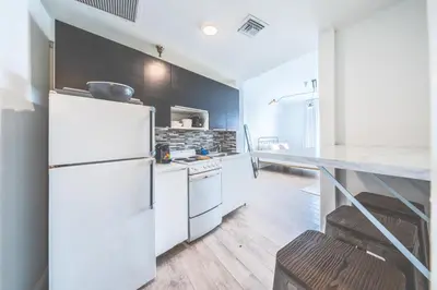 a kitchen with a white refrigerator and a counter at Amazing studio in Ocean Drive in Miami Beach