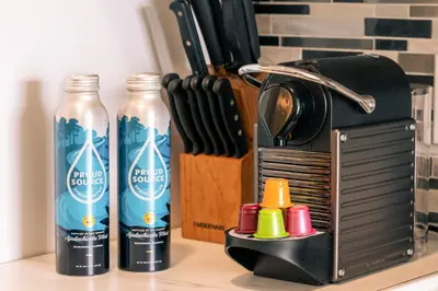 a kitchen counter with two bottles of water and a toaster at Amazing studio in Ocean Drive in Miami Beach