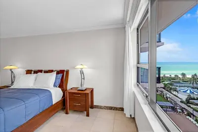 a bedroom with a bed and a view of the ocean at 2 Bedrooms Unit OceanFront Resort The Alexander in Miami Beach