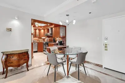 a dining room with a table and chairs in a kitchen at 2 Bedrooms Unit OceanFront Resort The Alexander in Miami Beach