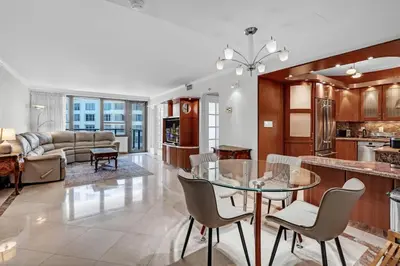 a kitchen and living room with a glass table and chairs at 2 Bedrooms Unit OceanFront Resort The Alexander in Miami Beach