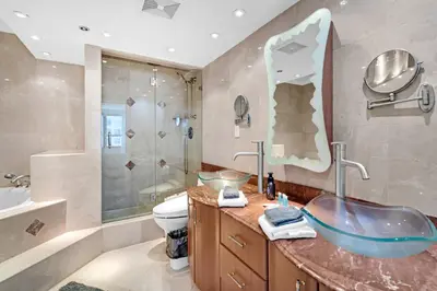 a bathroom with a sink and a toilet and a shower at 2 Bedrooms Unit OceanFront Resort The Alexander in Miami Beach