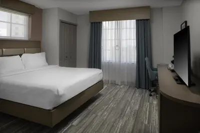 a hotel room with a bed and a desk and a television at Hilton Garden Inn Miami South Beach in Miami Beach