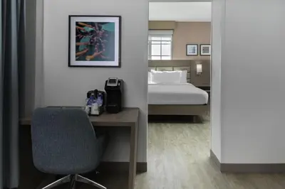 a bedroom with a bed and a desk and a chair at Hilton Garden Inn Miami South Beach in Miami Beach